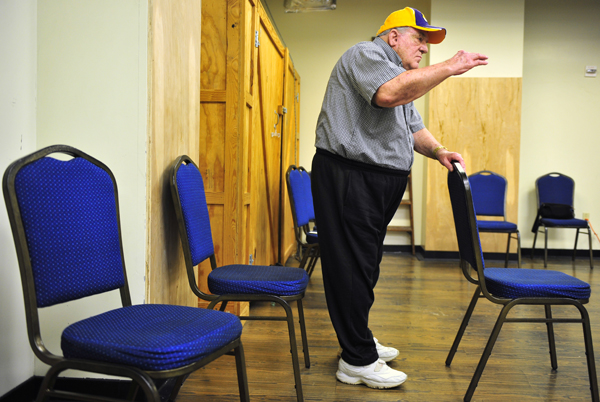 Frederick Landry, of Brusly, steadies himself with a chair during a tai chi class at LSU. The class aim is to help people with peripheral neuropathy, which affects movement and balance.